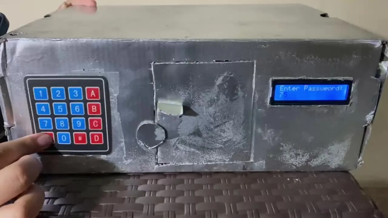The finished smart safe: a metal box with a keypad and a blue LCD screen
